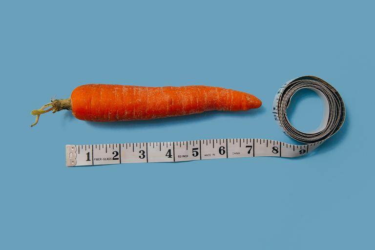 carrot and measuring tape on a blue background