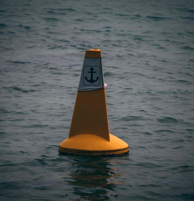 orange buoy with anchoring symbol label
